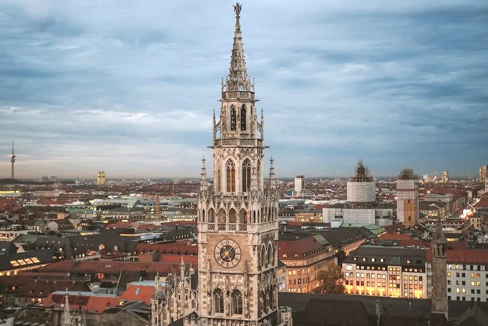 weite Außenaufnahme des Münchner Rathausturms im Hintergrund zahlreiche Dächer